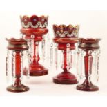 Pair of Victorian enamelled ruby glass lustres, with scalloped rims, decorated with floral