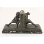 Pair of French spelter bookends, circa 1900, cast as a primitive man and woman dressed in furs