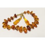 Polish Baltic amber pebble bracelet, mounted with 18ct yellow gold and set with 21 pebbles, the