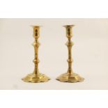 Pair of George III brass candlesticks, circa 1780, with knopped stems over a petalled foot, height