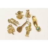 Small assortment of gold charms, including two Continental 18ct gold items, being a mandolin and a