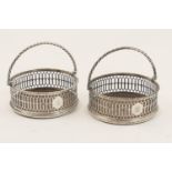 Pair of George III silver wine coasters, London 1769, pierced circular form with a rope twist
