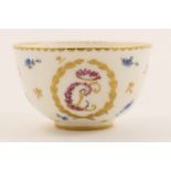 Sevres soft paste porcelain tea bowl, decorated with a monogram in gold and a floral bouquet for