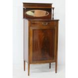 Edwardian mahogany and inlaid bow front music cabinet, circa 1900, the back with an oval mirror