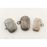 Three silver vesta cases comprising Chester 1898, with vacant shield shaped cartouche, scroll