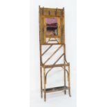 Victorian bamboo mirrored hallstand, circa 1885, with coat pegs against rattan panels flanking a