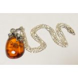 Polish Baltic amber pendant necklace, pear shaped stone approx. 40mm x 25mm, in an Art Nouveau