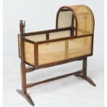 Victorian mahogany and bergere cradle on stand, of traditional design, raised on turned supports