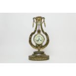 French painted wooden and ormolu mounted lyre form mantel clock, circa 1900, surmounted with a