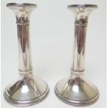 Pair of George V silver candlesticks, Birmingham 1919, plain columns over loaded trumpet base,