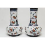 Pair of Keeling & Co. Losol ware bottle vases, decorated in a Japanesque style with birds amidst