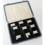 Cased set of six Amnora silver sandwich flags, with a number of additional interchangeable celluloid