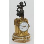 French ormolu and bronze mantel clock, circa 1900, surmounted with a bronze cherub emblematic of