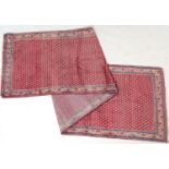 Araak red ground woollen runner, the field dispersed with myriad of small botehs, size 431cm x 109cm