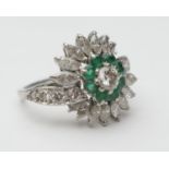 Emerald and diamond cluster ring, central round brilliant cut diamond of approx. 0.25ct, bordered