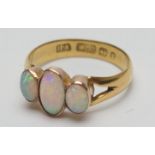 Opal three stone ring, the cabochon opals in beaded collet mounts, later worked on a Victorian
