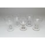 Four Victorian engraved glass rummers and a plain rummer (5)