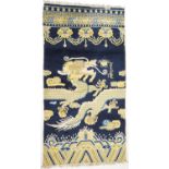 Traditional Chinese woollen pillar rug, 19th Century, having a five toed dragon clutching a