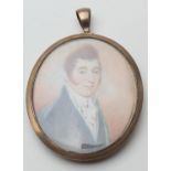 Late George III gold framed mourning locket, circa 1790-1810, inset with a portrait miniature of a