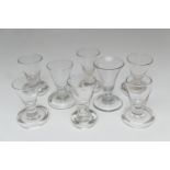 Eight dram or firing glasses, including trumpet example with air bubble to the stem, height 10cm