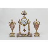 French scagliola marble clock garniture, circa 1900, the clock surmounted with a classical urn