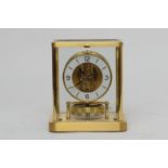 Jaeger Le Coultre brass Atmos clock, mid 1970s, having a white chapter ring with Arabic and baton