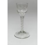 George III opaque twist wine glass, circa 1770, ogee bowl engraved with a floral spray, over a
