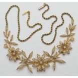 Late Victorian 15ct gold pearl floral necklace, circa 1900, having three flowerheads inset with