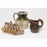 Brampton salt glazed stoneware toast rack, 23cm; also a Victorian treacle glazed hunting ware jug,