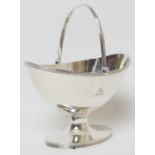 George III silver sugar basket, Maker I.R, London 1798, oval form with reeded edge and swing handle,