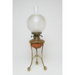 In the manner of W.A.S. Benson, brass and copper oil lamp, with a frosted spherical shade, copper
