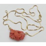 Carved coral pendant necklace, the coral carved with leaves, suspended from an 18ct gold boxlink