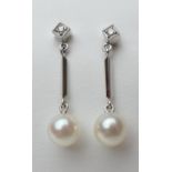 Pair of diamond and cultured pearl pendant earrings, in 14ct white gold, the pearls of approx. 13