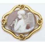 Victorian carved shell cameo brooch, circa 1870, carved with an angel playing a pipe amidst