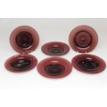 Six late Victorian amethyst glass bottle coasters, shallow circular form with ground pontil mark,