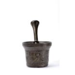A mortar with pestle dated 1674