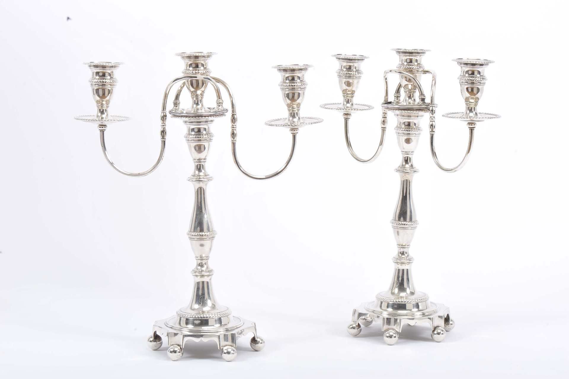 A pair of three-light serpentine candlesticks