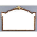 A Walnut and Gilt Overmantel Mirror of Shaped Outline of "18th Century" design, 1930's, with bold