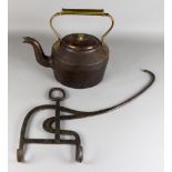 A Wrought Iron Kettle Tilt, 18th Century, with upturned handle, and a Victorian cast iron 6 pint