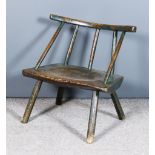An 18th/19th Century Irish Green Painted Low Stick Back Windsor Armchair of primitive form, with