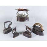 A Cast Iron Brass Mounted Oval Box Iron, 19th Century, and Four Other Irons, the box iron with