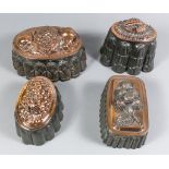 Four Copper and Tinned Metal Jelly Moulds, Victorian, one moulded with pear, pineapple and apple,