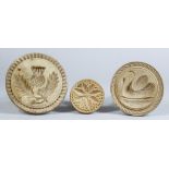 Three Carved Wood Butter Stamps, Victorian, carved with a thistle and leaves, 4.875ins diameter, a
