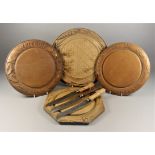 Four Turned and Carved Wood Bread Boards, Late Victorian, one carved with ribbons, wheat ear motifs