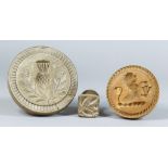 Three Carved Wood Butter Stamps, Victorian, carved with a thistle and leaves, 4.75ins diameter, an