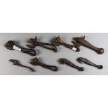 Eight Cast Iron Tin Openers, 19th Century, three cast with bulls heads and tails, largest 6.75ins