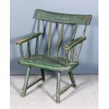 A 19th Century Irish Green Painted Stick Back Windsor Armchair of primitive form, with curved