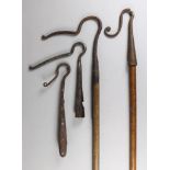 A Wrought Iron Shepherd's Crook, with wooden handle, 52.25ins, another, 53.75ins, and two without