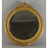 A Gilt Framed Circular Wall Mirror, the frame with simple gesso moulding, surmounted by a cresting