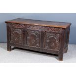 A 17th Century Panelled Oak Coffer, the plain two-plank lid with moulded edge to top, the frieze